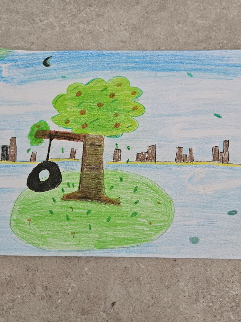 A coloured pencil drawing of a large green fruit tree with a tyre swing hanging from one of its branches, set on a grassy mound with a city skyline and blue sky in the background.