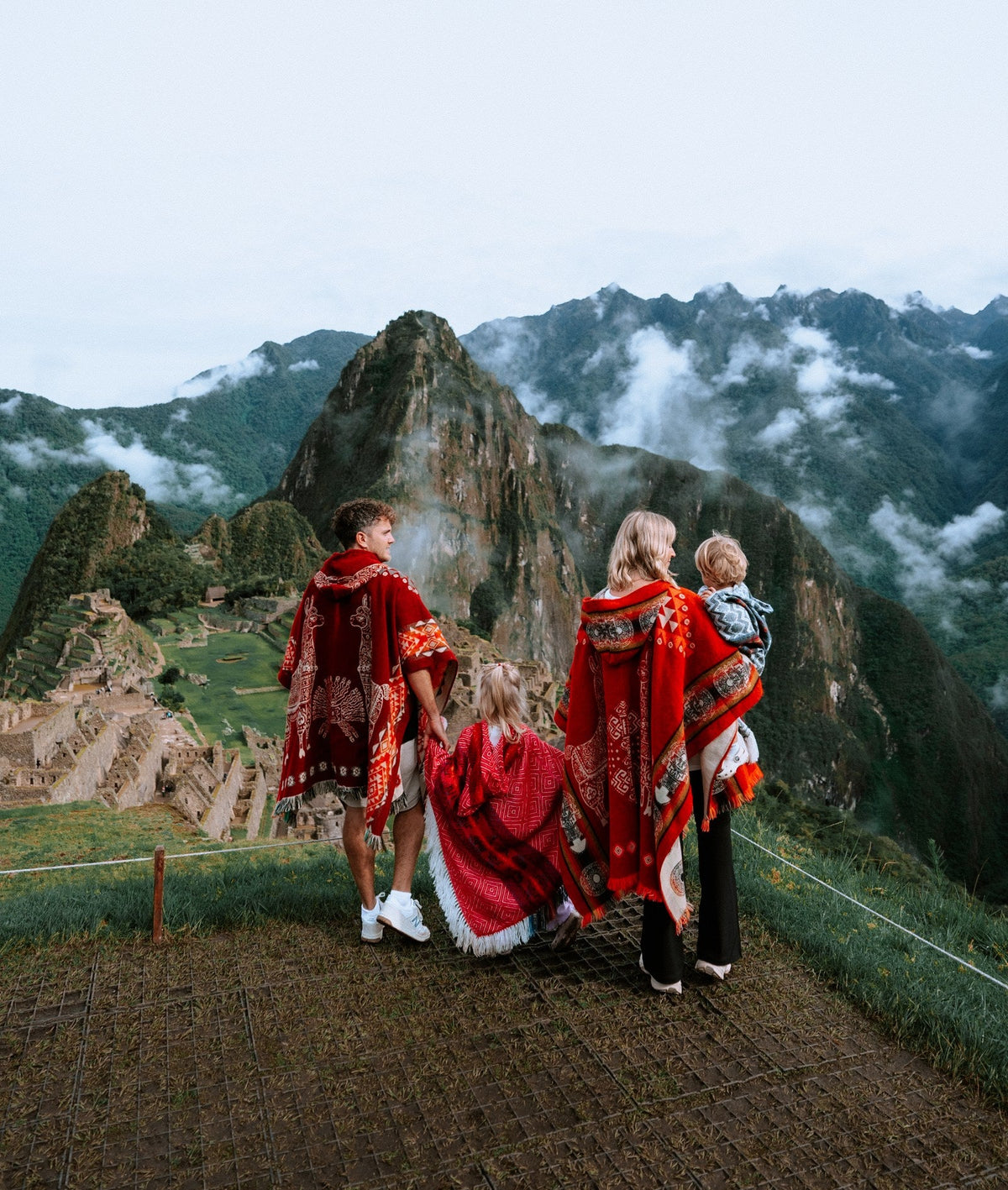 The Flying the Nest family in red ponchos at Machu Picchu.