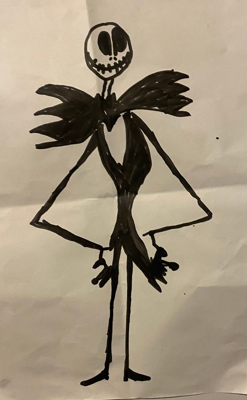 A black marker drawing of a tall, skinny skeleton character with a wide grinning face, large eye sockets, and outstretched arms with clawed hands. The figure has jagged wing-like shapes at the shoulders and stands on thin stick-like legs.
