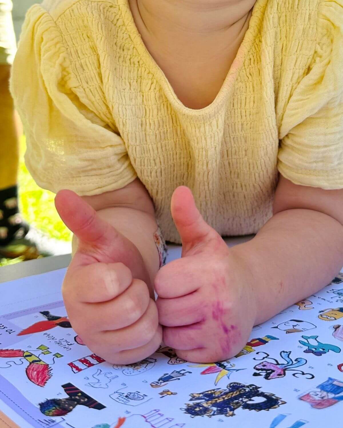 An Australian kid drawing alongside their copy of theINmag.