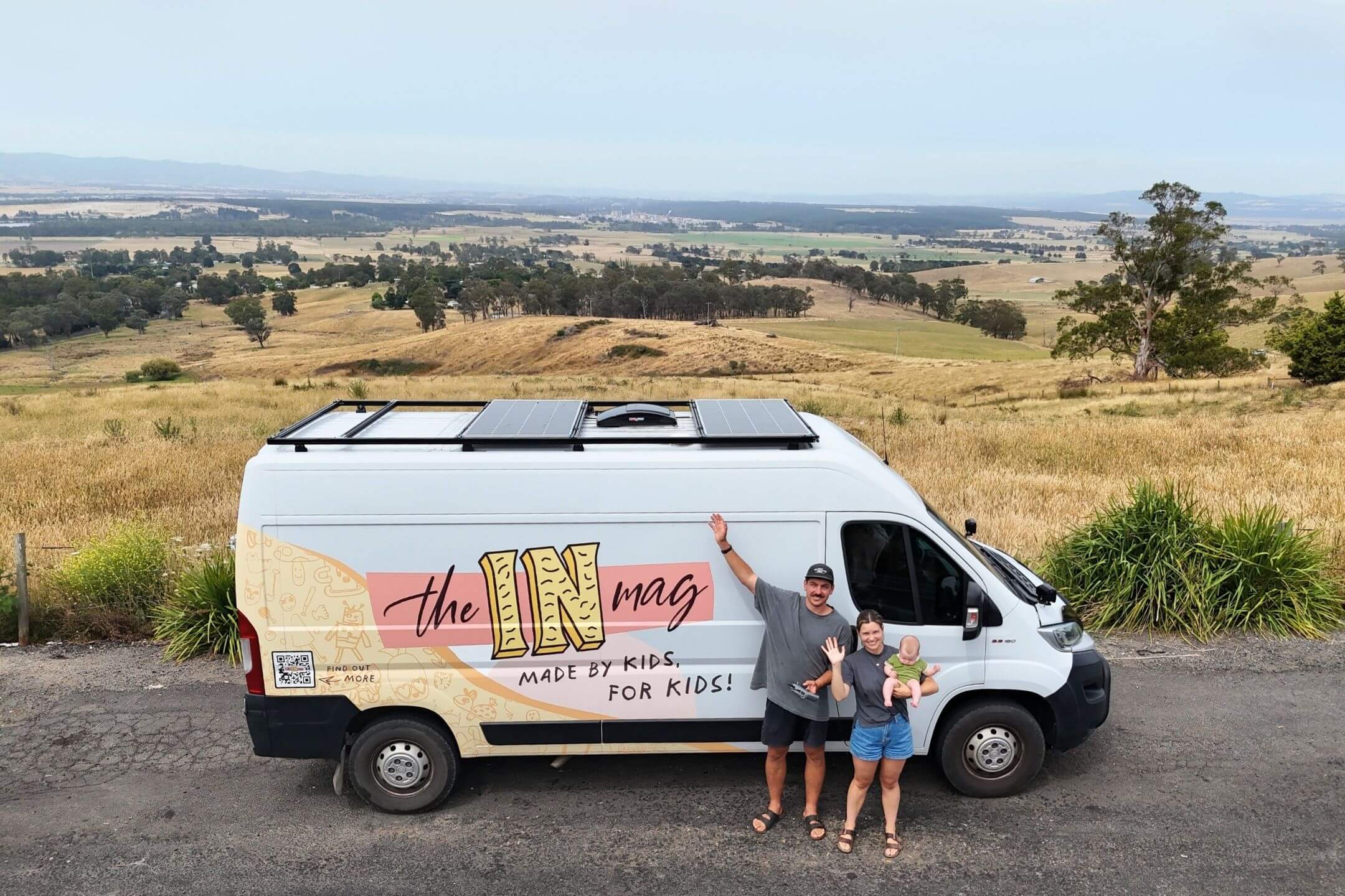 Aerial drone shot of theINmag founders Ryan and Tam standing in front of their self-converted home-on-wheels van.