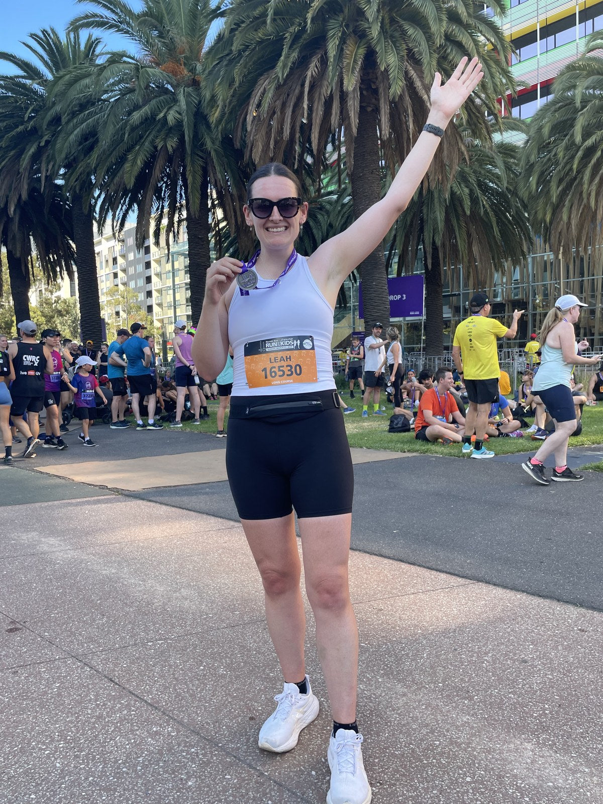 Leah running in a race wearing a competitor bib.